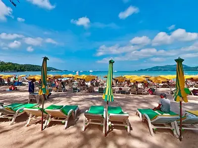 a group of chairs and umbrellas on a beach at Bangla Jacuzzi Suite 212 in Patong Beach