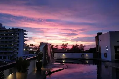 a sunset on the roof of a building at Bangla Jacuzzi Suite 212 in Patong Beach
