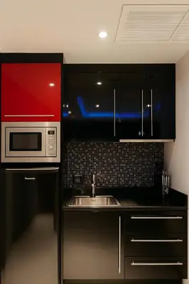a kitchen with a microwave and a sink at Bangla Jacuzzi Suite 212 in Patong Beach