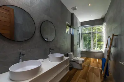 a bathroom with two sinks and a mirror at Phang nga Villas Private Pool & Tropical Retreats