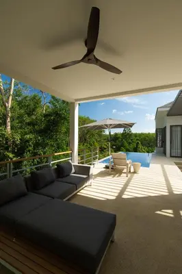 a living room with a couch and a patio at Phang nga Villas Private Pool & Tropical Retreats