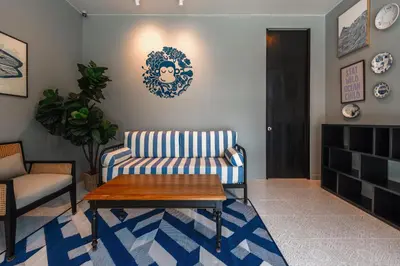 a living room with a couch and a coffee table at Blu Monkey Boutique Naiharn Beach in Nai Harn Beach
