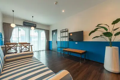 a living room with a couch and a table at Blu Monkey Boutique Naiharn Beach in Nai Harn Beach
