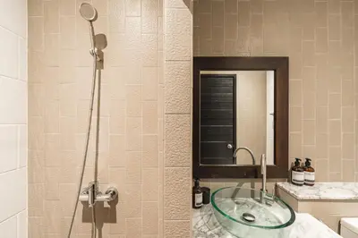 a bathroom with a glass sink in a shower at Blu Monkey Boutique Naiharn Beach in Nai Harn Beach