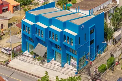 an overhead view of a blue building with people looking out the windows at Blu Monkey Boutique Naiharn Beach in Nai Harn Beach