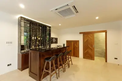 a bar with a bunch of bottles of wine at Luxe & Privacy Orchard Villas Pasak 4BR in Laguna Phuket