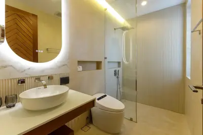 a bathroom with a sink and a toilet and a mirror at Luxe & Privacy Orchard Villas Pasak 4BR in Laguna Phuket