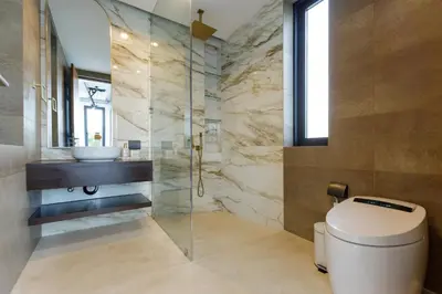 a bathroom with a toilet and a sink at Luxe & Privacy Orchard Villas Pasak 4BR in Laguna Phuket