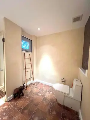 a bathroom with a cat standing next to a toilet at Spacious 3 bedroom, 100m walk to Layan Beach in Phuket
