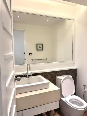 a bathroom with a sink and a toilet and a mirror at Spacious 3 bedroom, 100m walk to Layan Beach in Phuket