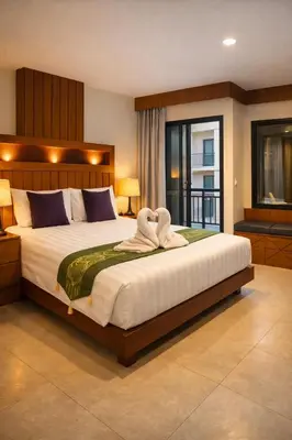 a bedroom with a large bed with towels on it at The Aura Patong in Patong Beach