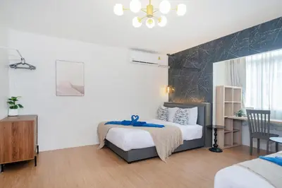 a bedroom with a bed and a desk in it at Chill Beach Bangla comfy bed and pool 3 bedrooms 10pax in Patong Beach