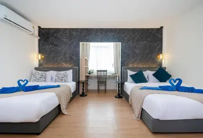 a bedroom with two beds with blue bows on them at Chill Beach Bangla comfy bed and pool 3 bedrooms 10pax in Patong Beach