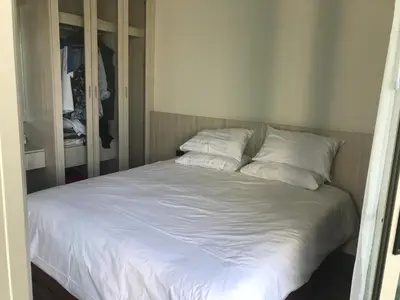a bed with white sheets and pillows in a bedroom at OCEANA Kamala SeaviewCondo B41 in Kamala Beach