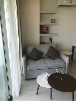 a living room with a couch and a table at OCEANA Kamala SeaviewCondo B41 in Kamala Beach