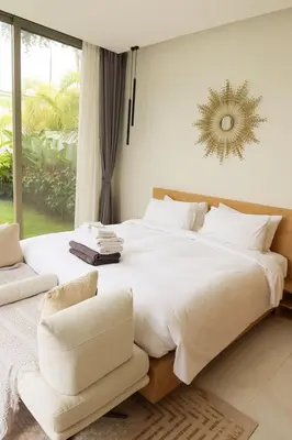 a bedroom with a large white bed and a chair at Phuket luxury Asherah villa Bang Tao in Ban Phru Champa