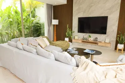 a living room with a white couch and a tv at Phuket luxury Asherah villa Bang Tao in Ban Phru Champa