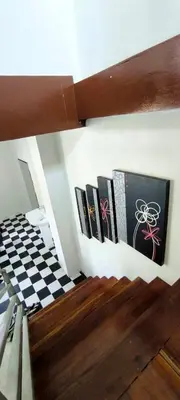 a group of books hanging on a wall at Leamsai Whisper Home in Thalang