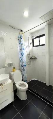 a bathroom with a toilet and a sink and a shower at Leamsai Whisper Home in Thalang