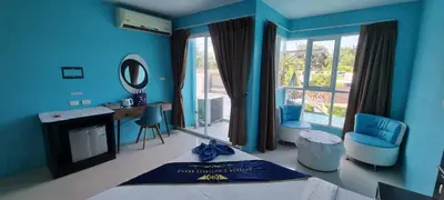 a blue room with a bed and a desk and a mirror at Bedroom201 Kata Beach Phuket in Kata Beach