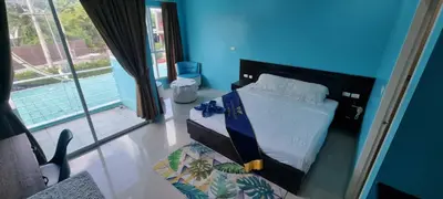 a bedroom with a bed in a blue room at Bedroom201 Kata Beach Phuket in Kata Beach