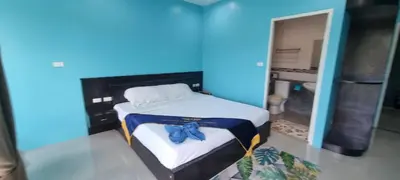 a blue room with a bed with a bow tie on it at Bedroom201 Kata Beach Phuket in Kata Beach
