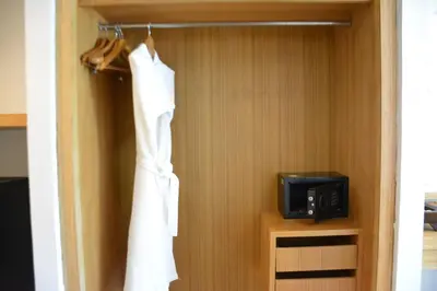 a closet with a microwave and a towel on a rack at Zephyr Suites in Patong Beach