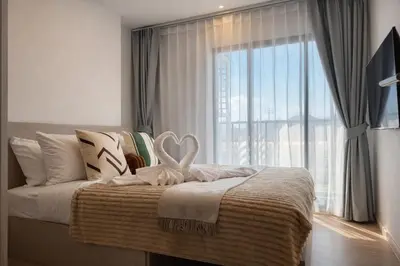 a bedroom with a bed with a large window at Work & Travel in Kathu