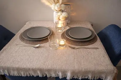 a table with plates and glasses and candles on it at Work & Travel in Kathu