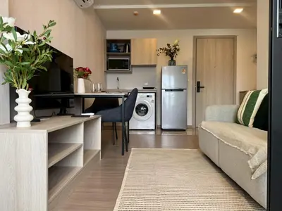 a kitchen and living room with a couch and a refrigerator at Work & Travel in Kathu