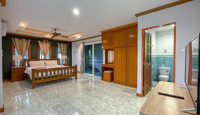 a bedroom with a bed and a bathroom at The Beige Pool Villa Bang Tao Phuket in Ban Thalat Choeng Thale