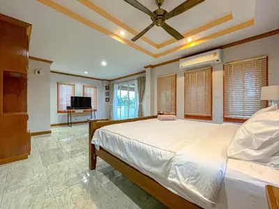 a bedroom with a large bed with a ceiling at The Beige Pool Villa Bang Tao Phuket in Ban Thalat Choeng Thale