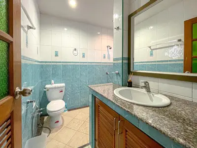 a bathroom with a toilet and a sink and a mirror at The Beige Pool Villa Bang Tao Phuket in Ban Thalat Choeng Thale