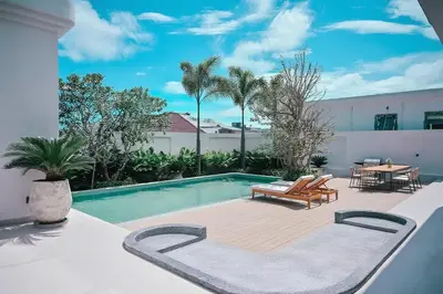 a swimming pool with a wooden deck and a table at Étoile Kata Luxury Pool Villas by Astra in Kata Beach