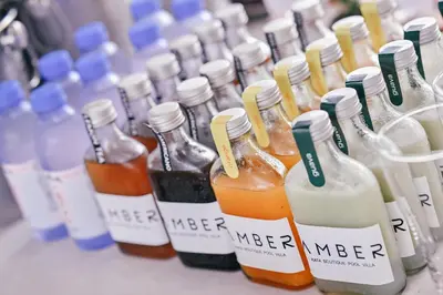 a row of bottles of alcohol on a table at Étoile Kata Luxury Pool Villas by Astra in Kata Beach