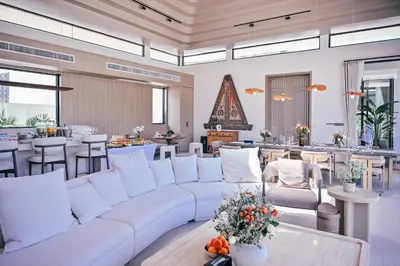 a living room with a white couch and tables at Étoile Kata Luxury Pool Villas by Astra in Kata Beach