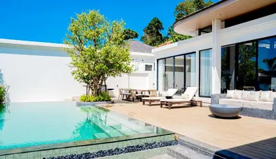 a villa with a swimming pool and a house at Étoile Kata Luxury Pool Villas by Astra in Kata Beach