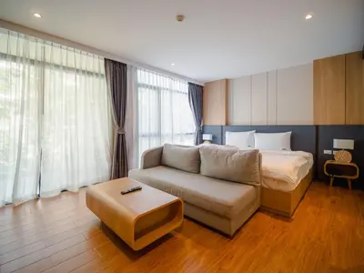 a living room with a couch and a bed at Wyndham Garden 1220 Modern Studio Next to Naithon in Phuket Town