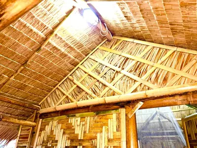 a ceiling of a wooden building with a light on it at Patong Canal House 2 in Patong Beach