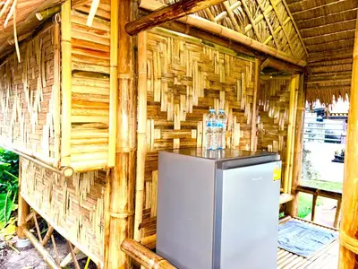 a refrigerator in a room with a wooden wall at Patong Canal House 2 in Patong Beach