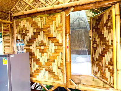 a woven wall in a building with a refrigerator at Patong Canal House 2 in Patong Beach