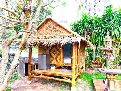 a small hut with a television in a garden at Patong Canal House 2 in Patong Beach