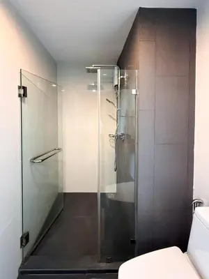 a glass shower in a bathroom with a toilet at 6th Avenue 2 bedroom in Surin Beach