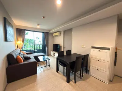 a living room with a couch and a dining room table at 6th Avenue 2 bedroom in Surin Beach