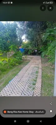 a brick road in the middle of a field at Bang Riss Kee Home Stay3 in Ko Yao Noi