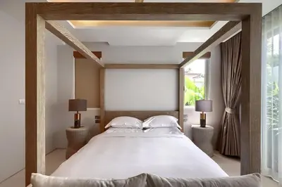 a bedroom with a large white bed with two lamps at Botanica Luxury Pool Villa Phuket in Thalang
