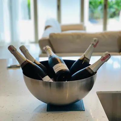 a bowl filled with bottles of wine on a table at Botanica Luxury Pool Villa Phuket in Thalang
