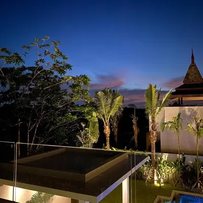 a night view of a villa with a swimming pool at Botanica Luxury Pool Villa Phuket in Thalang