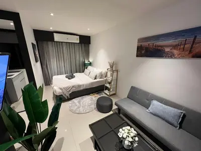 a living room with a bed and a couch at Utopia Central in Ban Ket Ho