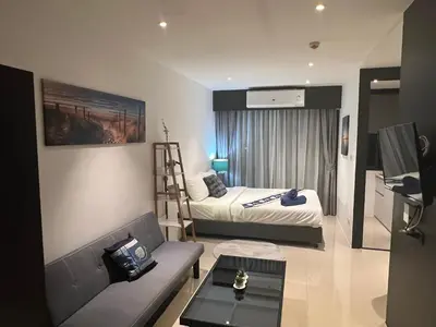a small living room with a bed and a couch at Utopia Central in Ban Ket Ho